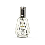 Clear perfume bottle with silver cap on a white background